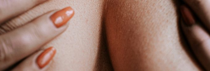 Womans breast and hands detail - stop the cancer